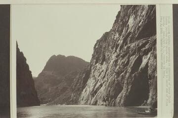 Black Canyon looking downstream at abutments of lower Black Canyon Dam site from Nevada side. Site is lower end of first canyon. Geologist F. L. Ransome in boat