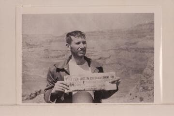 Bill Beer holding news account of the loss of Daggett and himself. South Rim
