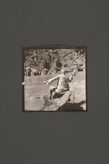 Joe Desloge carries on various activities during the repair of the "Cactus" below Tuna Creek Rapid. Here he heaves an empty can into the "treacherous river"