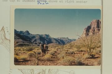 Down at right bank at Mile 220.1. The tip of Diamond Peak shows at right center