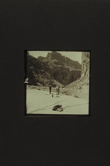 Preparing to depart from the head of President Harding Rapid. Taylor is at left. Eisaman walks toward Belknap. In "Rattlesnake" are Cutler, Desloge, and Sanderson. The other boat is the "Cactus."