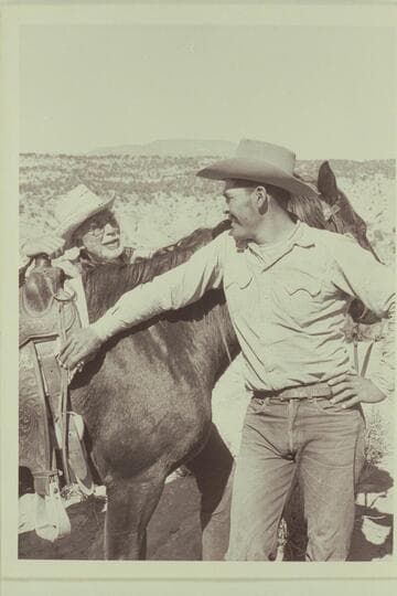 Masland talks over the finer points of horse-flesh with Bahe. Navajo Mountain on the horizon