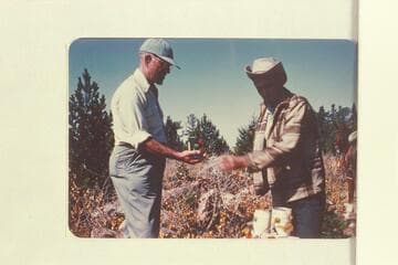 Marston gets some canned fruit from Daly. Lunch on top of Navajo Mountain