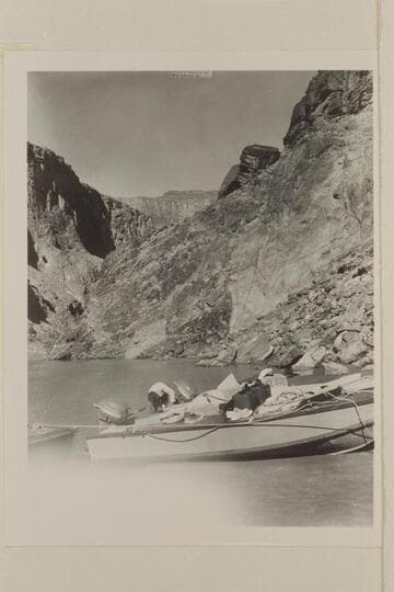 The two outboard boats, "Twin" and "June Bug" moored at camp at Mile 115 just above Elves Chasm. The fault at this point brings up the Archean in the background