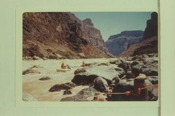 Lining Vulcan Rapid. Nevills perched on the sadiron; Joe Desloge at center; Garth Marston at lower right
